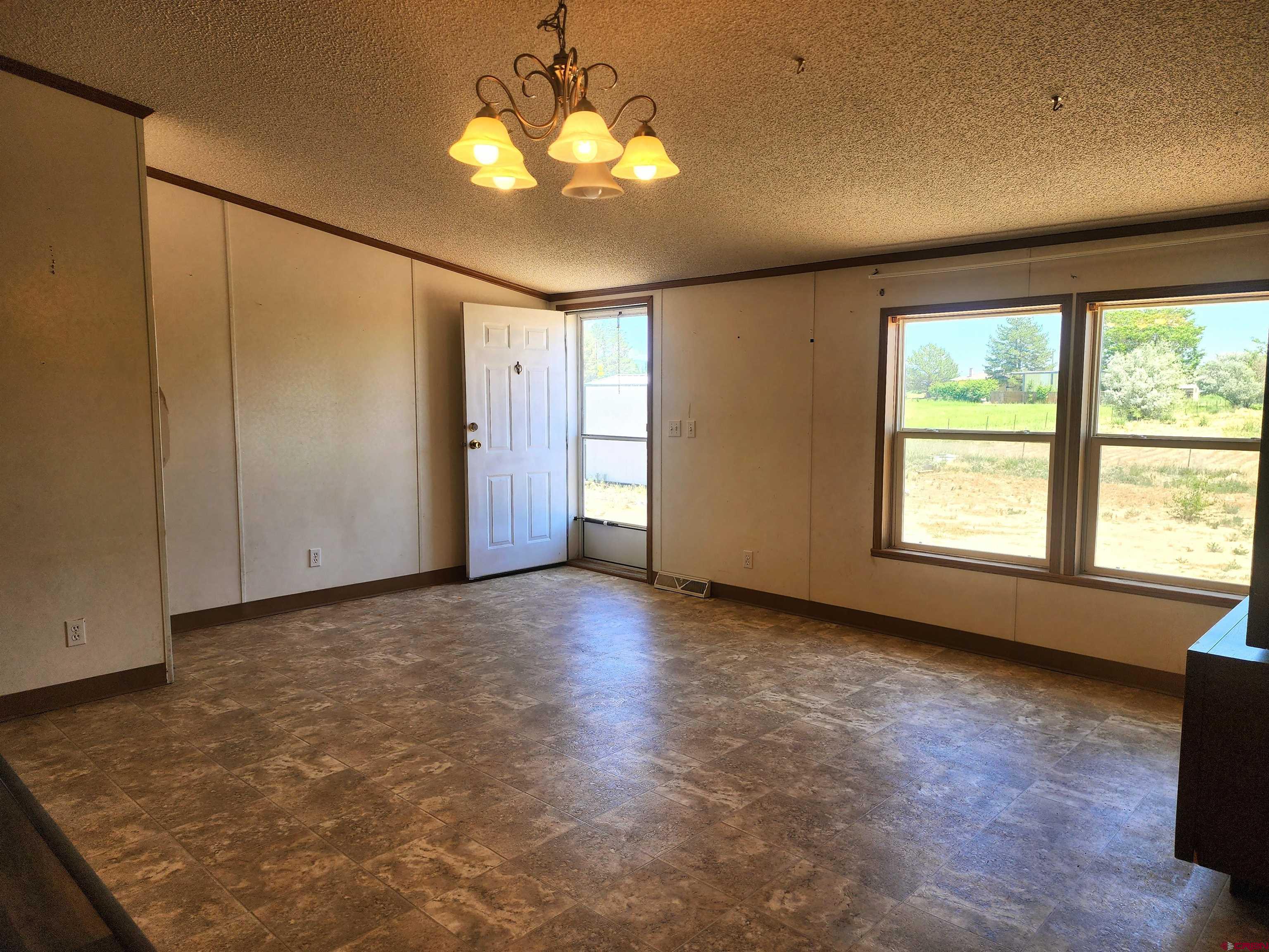 20897 Iris Road Austin, CO 81410 - Photo 17 of 29 a view of a livingroom with a ceiling fan and window