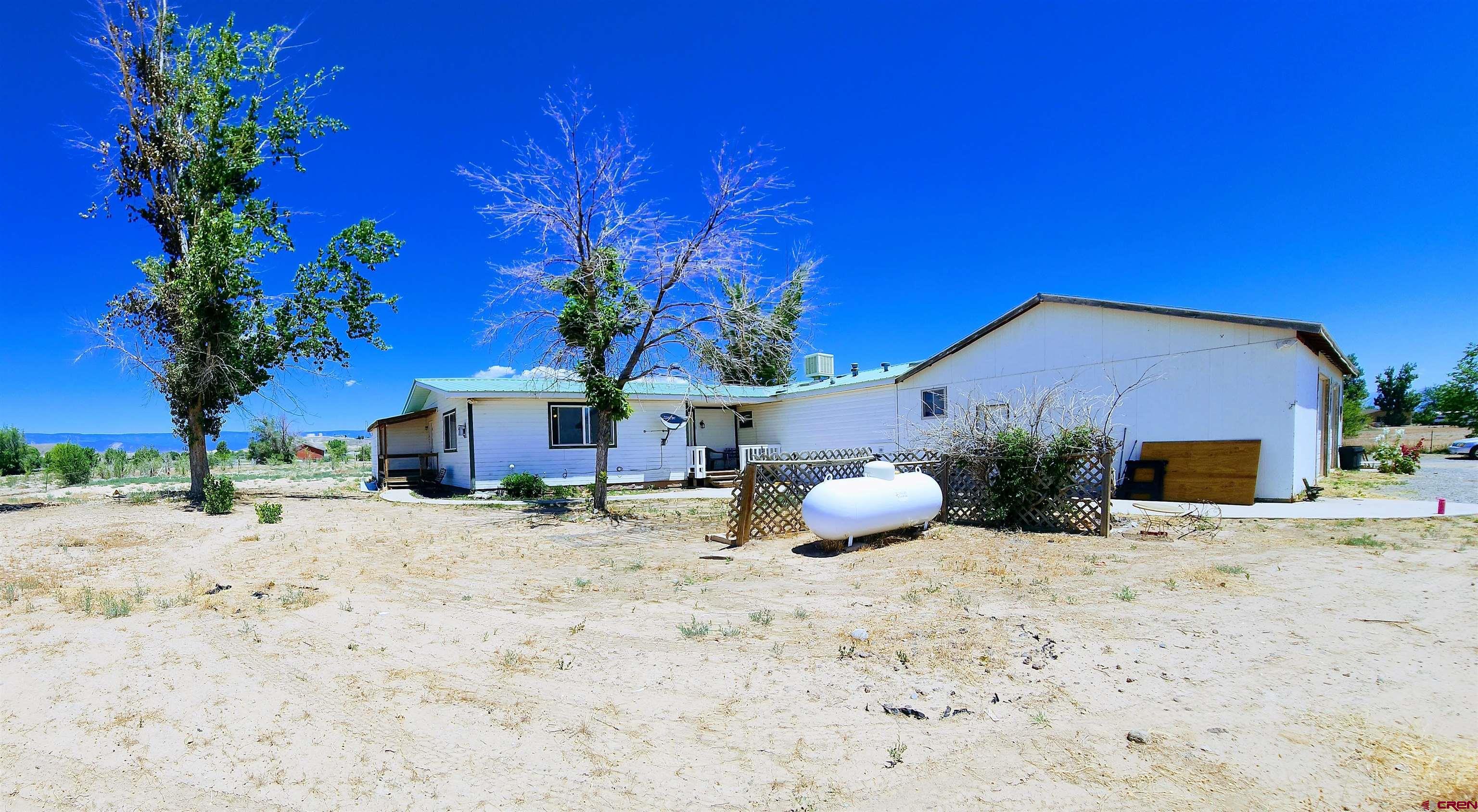 20897 Iris Road Austin, CO 81410 - Photo 2 of 29 a view of a house with a yard