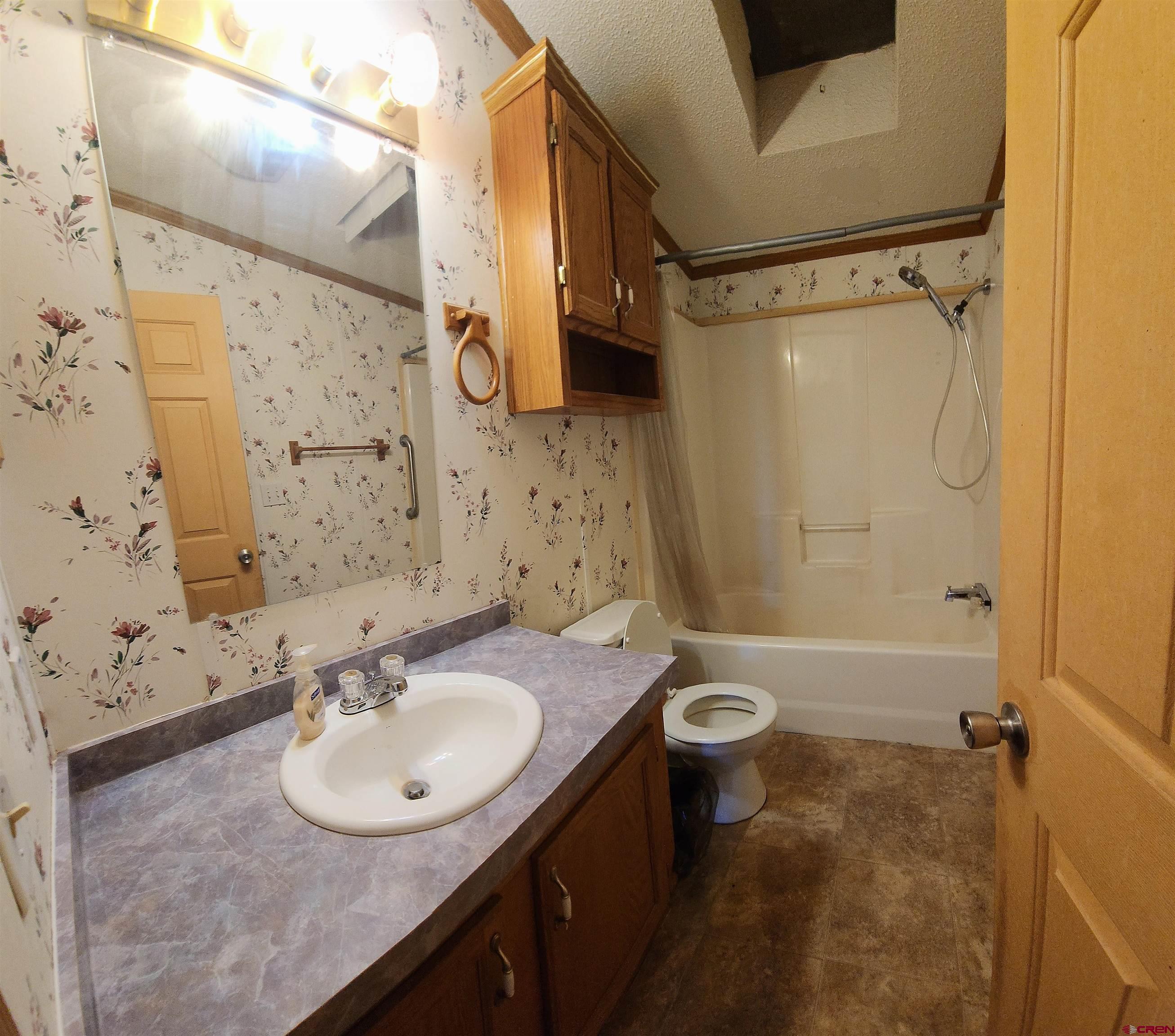 20897 Iris Road Austin, CO 81410 - Photo 24 of 29 a bathroom with a sink toilet and shower