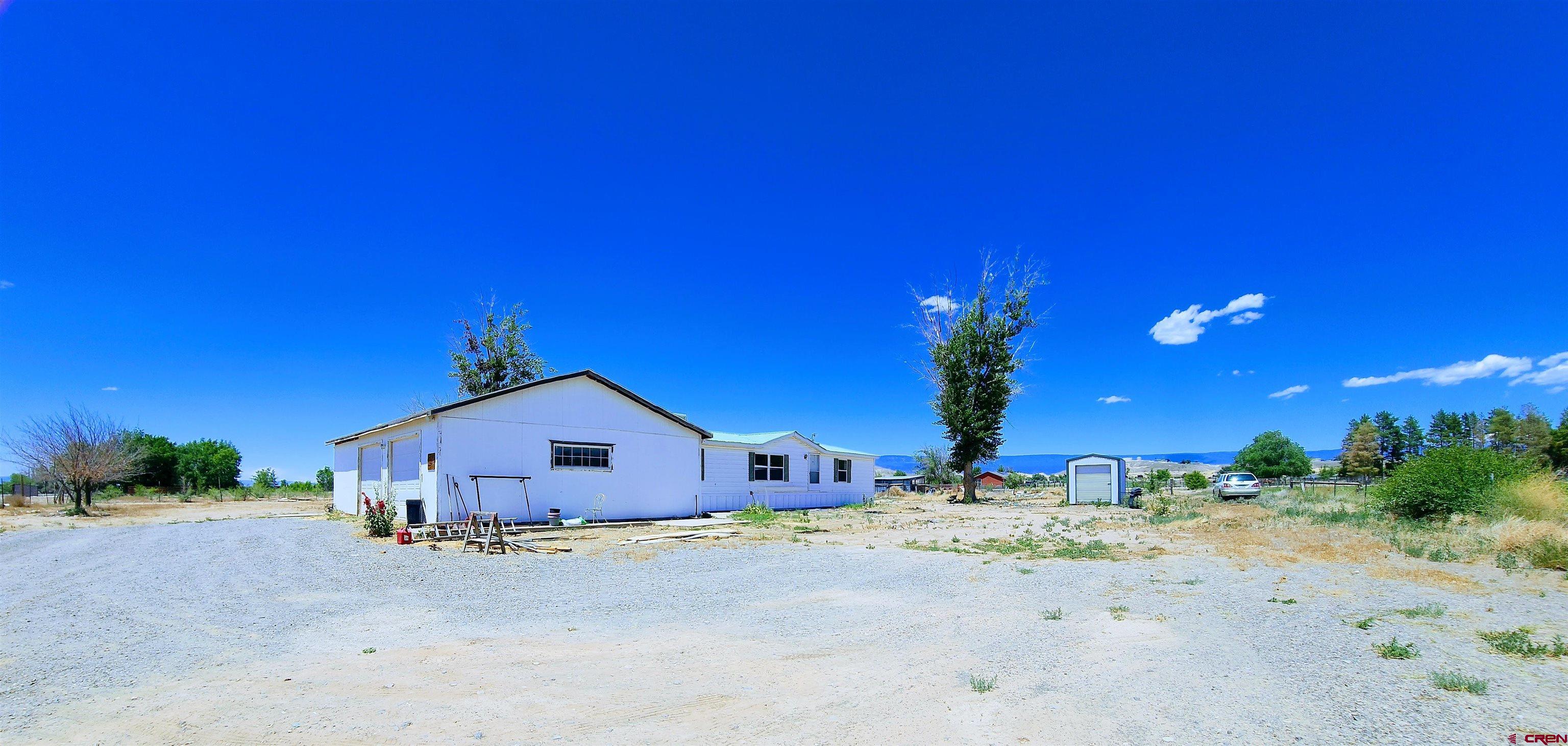 20897 Iris Road Austin, CO 81410 - Photo 25 of 29 a front view of a house with a yard