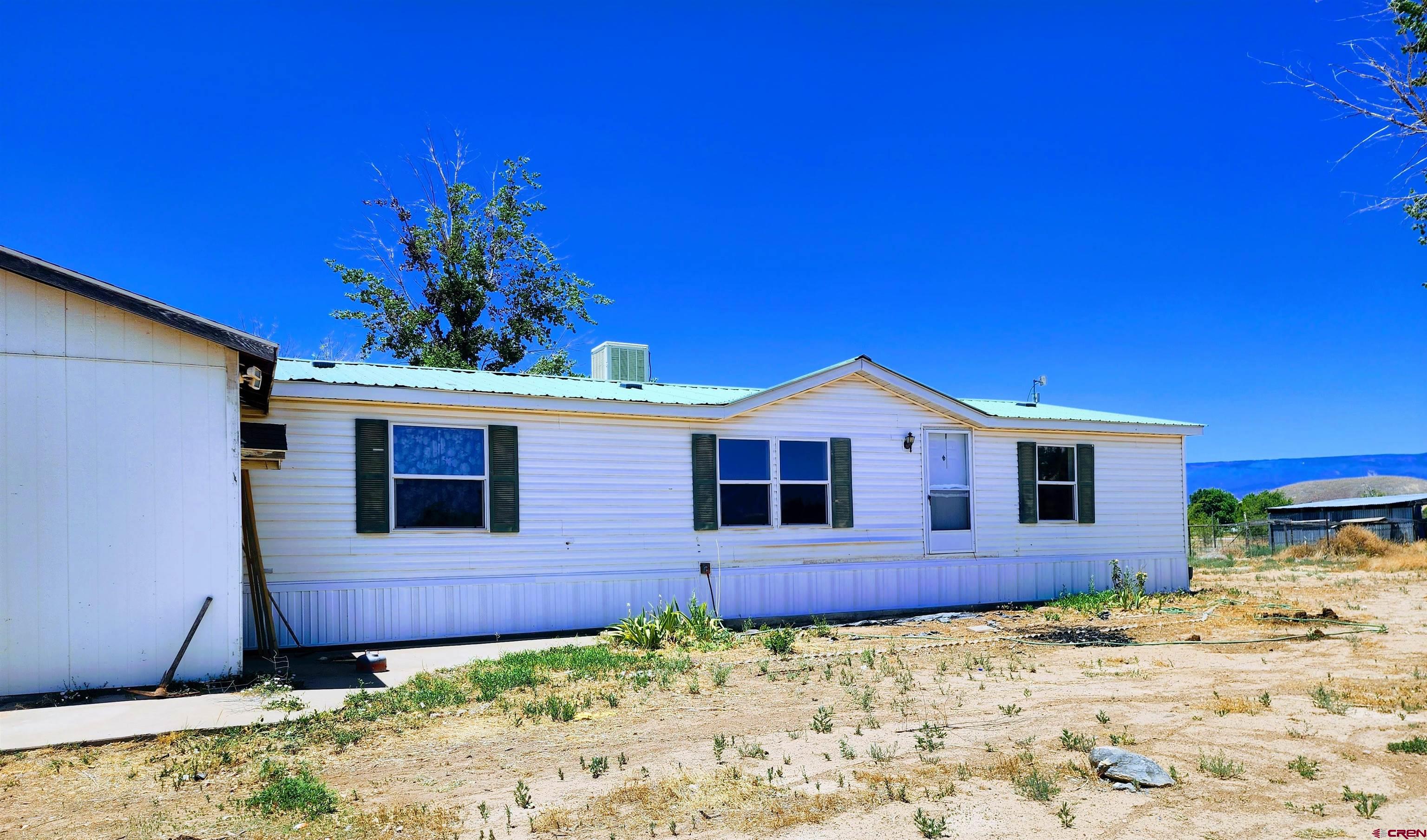 20897 Iris Road Austin, CO 81410 - Photo 6 of 29 a front view of a house with a yard