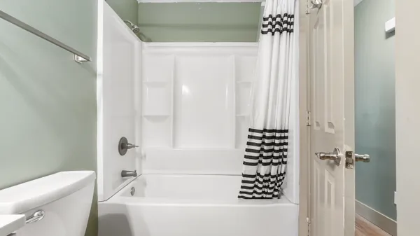 a bathroom with a bathtub and shower