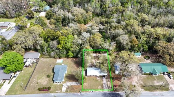 an aerial view of a houses with yard