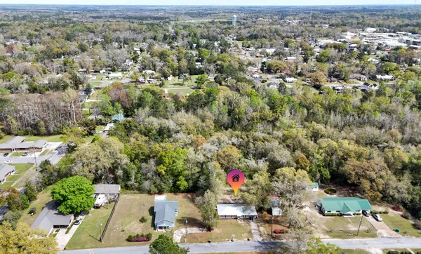 an aerial view of residential houses with city view
