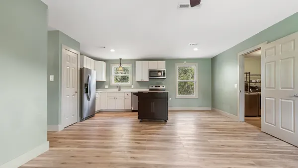 a kitchen with stainless steel appliances granite countertop a refrigerator and a sink
