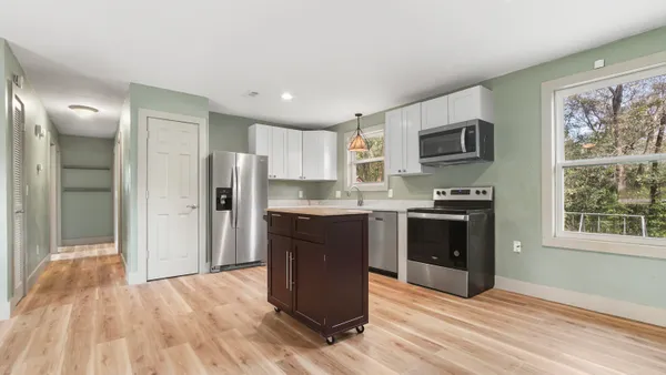 a kitchen with stainless steel appliances a refrigerator stove and sink