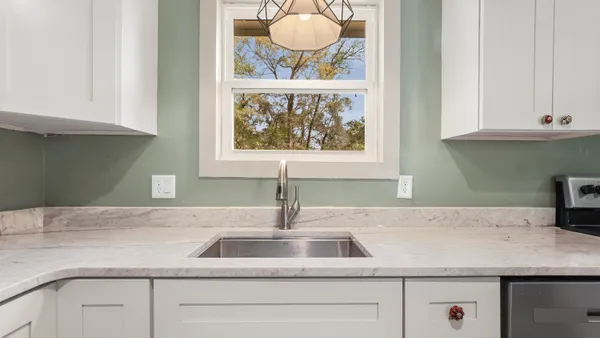 a sink with a granite top and a stove