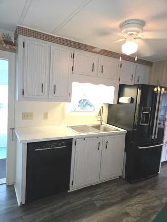 a kitchen with a sink cabinets and stainless steel appliances