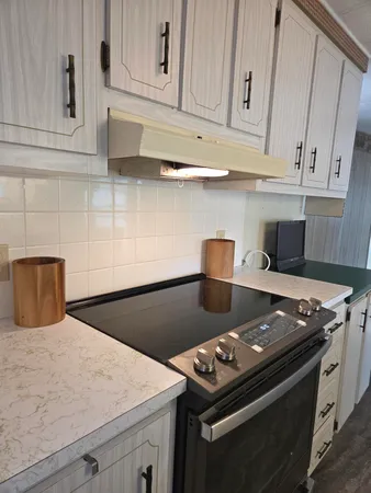 a stove top oven sitting inside of a kitchen