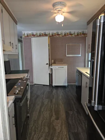 a kitchen with refrigerator and window