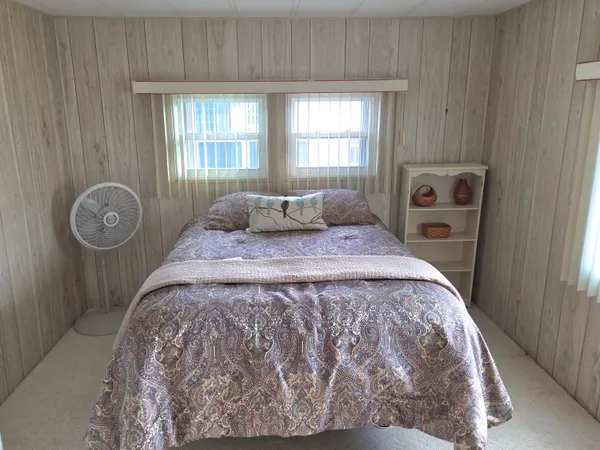 a bedroom with a bed and window