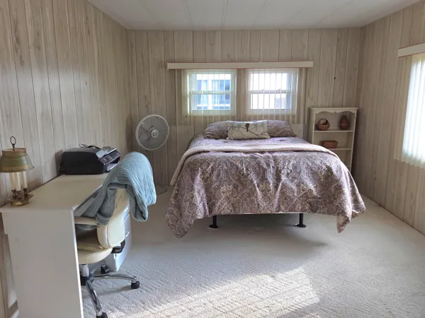 a spacious bedroom with a bed and a window