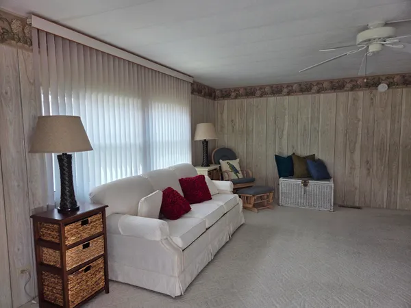 a living room with furniture and a lamp