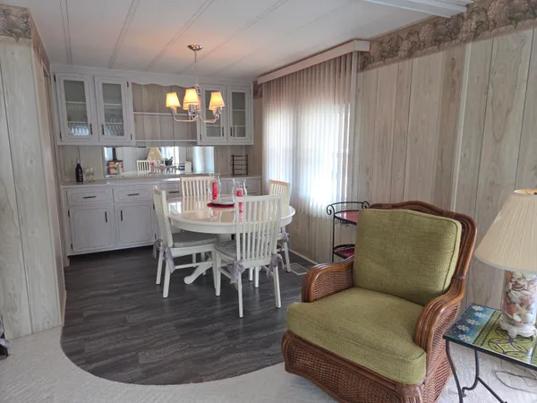 a living room with furniture a dining table and kitchen view