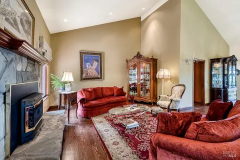 a view of a dining room with furniture and chandelier
