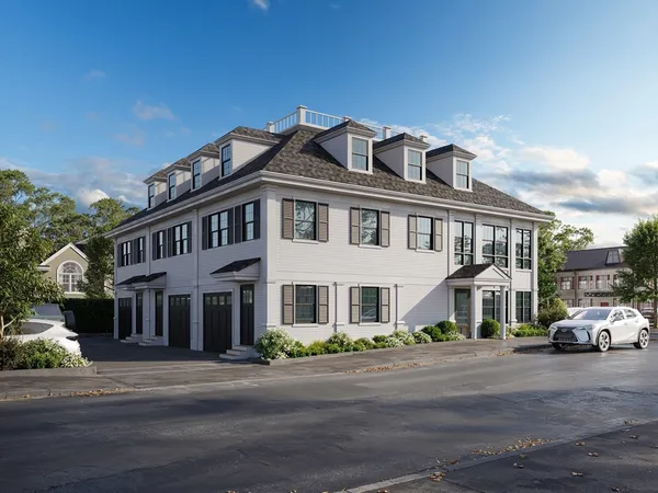 a city street lined with parked cars and buildings