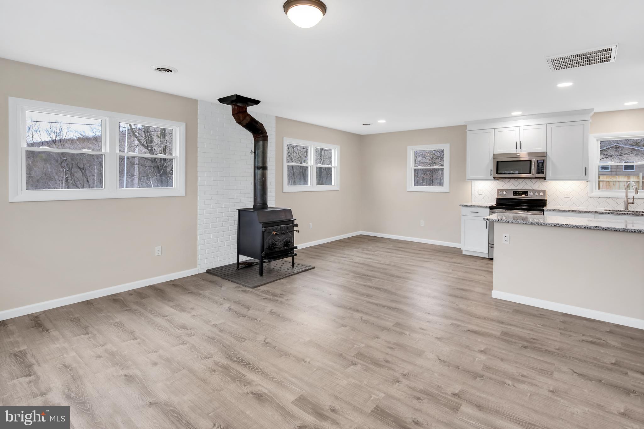 3406 Howellsville Road Front Royal, VA 22630 - Photo 13 of 29 Laminate (Vinyl plank) flooring, wood stove