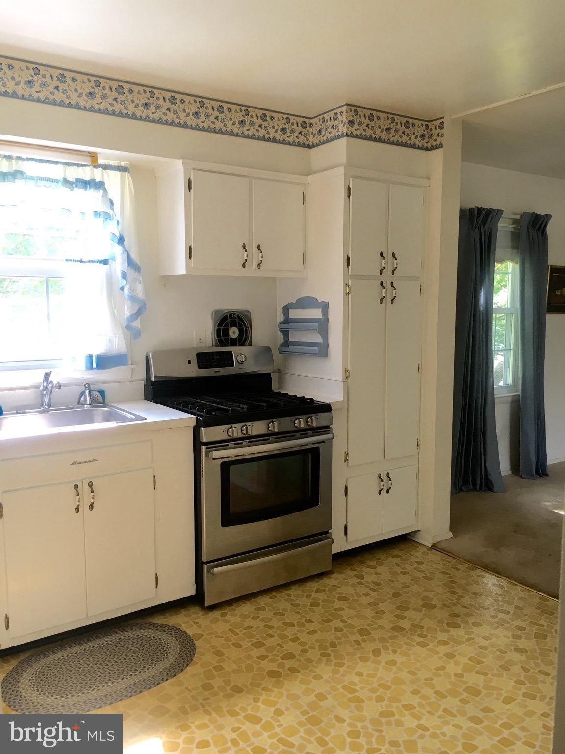 9003 Tammy Road Baltimore, MD 21236 - Photo 6 of 12 a kitchen with stainless steel appliances a stove and a refrigerator