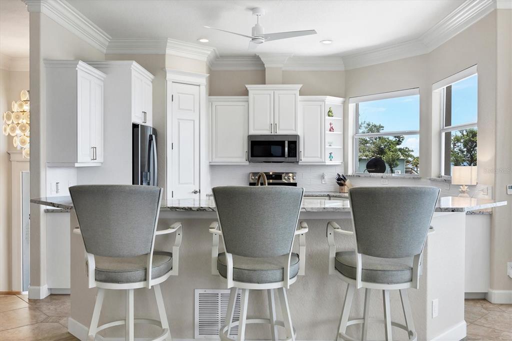 4111 North Beach Road Englewood, FL 34223 - Photo 23 of 87 a view of a dining room with furniture and a potted plant
