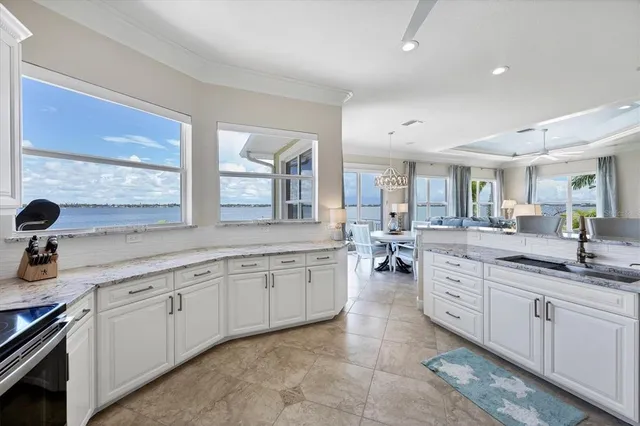 a bathroom with a granite countertop sink and a toilet