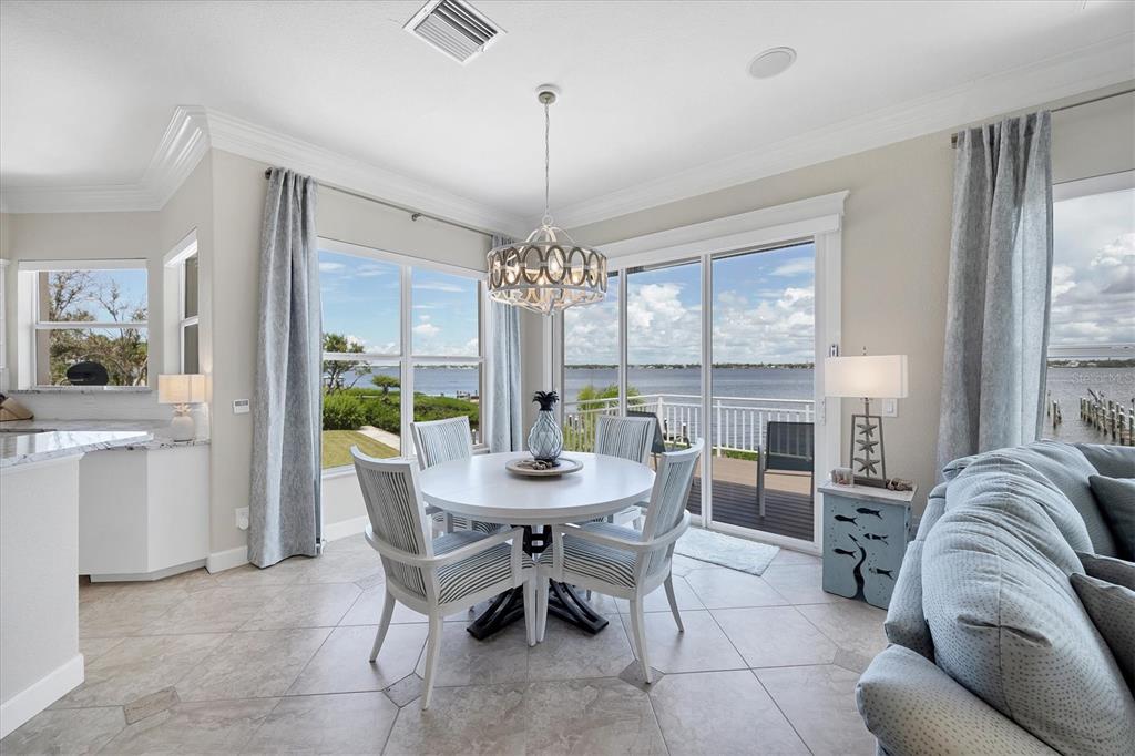 4111 North Beach Road Englewood, FL 34223 - Photo 28 of 87 a view of a dining room with furniture window and wooden floor