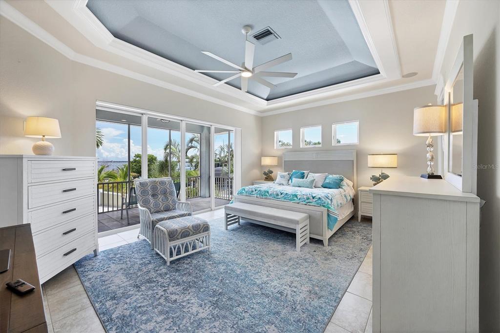 4111 North Beach Road Englewood, FL 34223 - Photo 30 of 87 a spacious bedroom with a bed and a couch