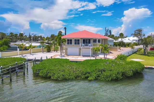 a view of a house with a yard patio and fire pit