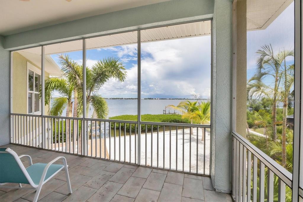 4111 North Beach Road Englewood, FL 34223 - Photo 33 of 87 a view of a balcony with floor to ceiling windows with wooden floor