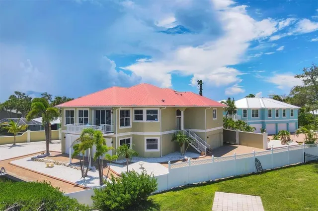 an aerial view of a house with a yard and lake view