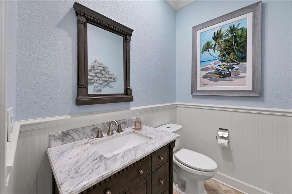 4111 North Beach Road Englewood, FL 34223 - Photo 43 of 87 a bathroom with a granite countertop sink and a toilet