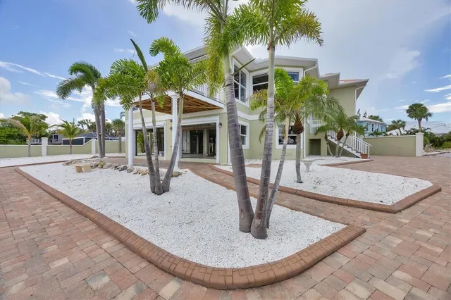 an aerial view of a house with a yard and outdoor seating
