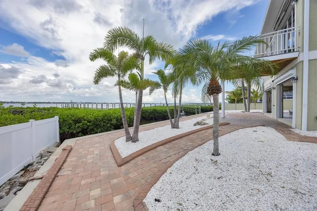 a living room with furniture and a dining table with kitchen view