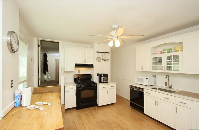 a kitchen with granite countertop a stove and a sink