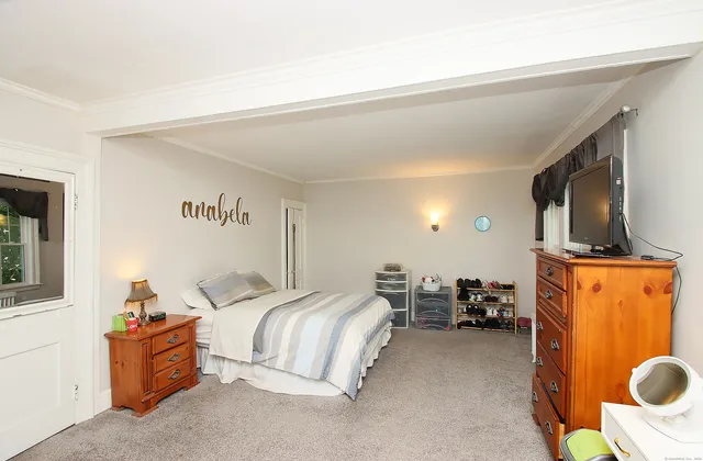 a bedroom with bed and window