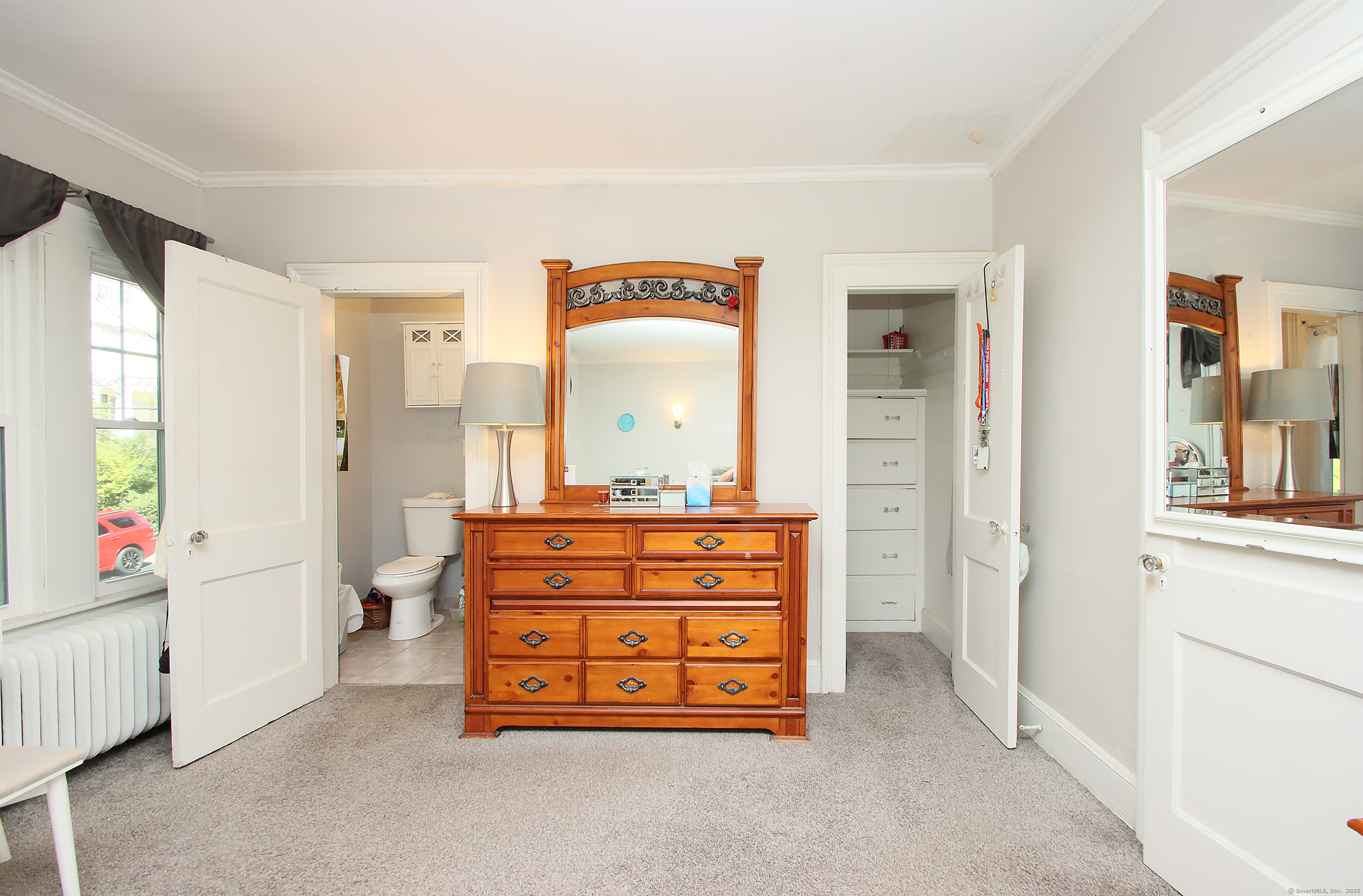 181 Buckingham Street Waterbury, CT 06710 - Photo 22 of 40 a room with a dresser and a mirror