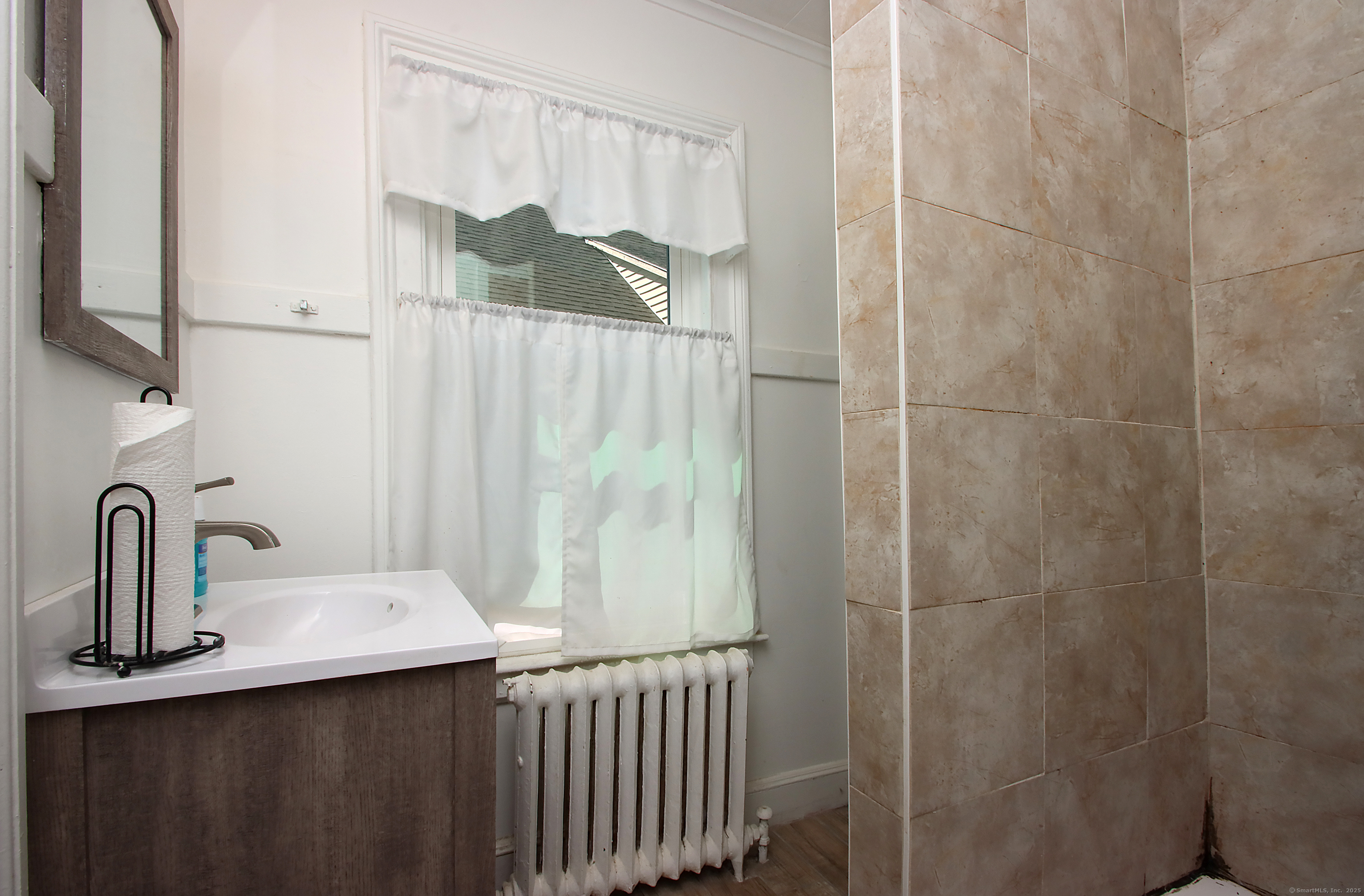 181 Buckingham Street Waterbury, CT 06710 - Photo 23 of 40 a bathroom with a sink and a mirror