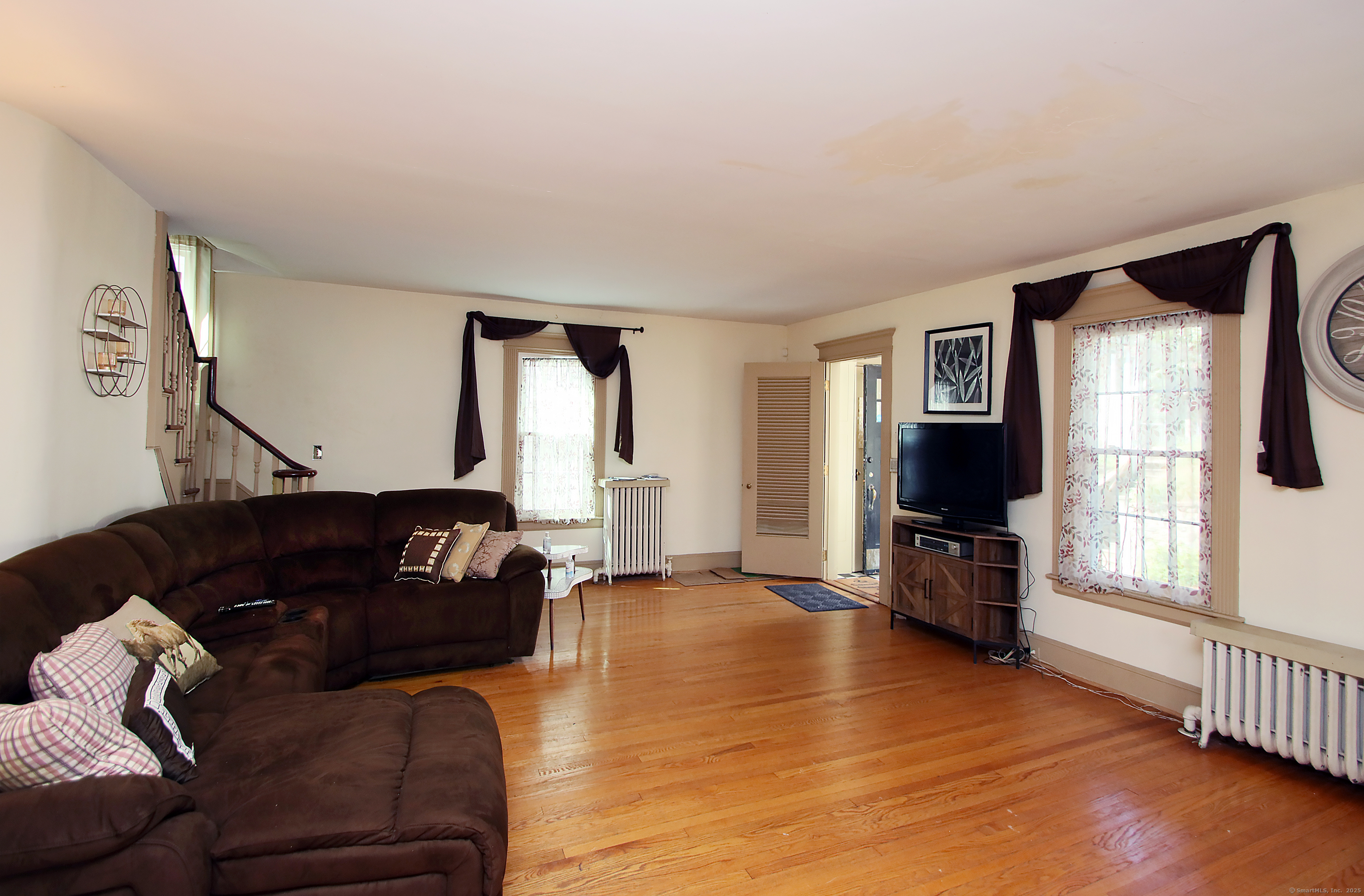 181 Buckingham Street Waterbury, CT 06710 - Photo 5 of 40 a living room with furniture and a flat screen tv