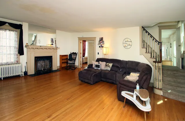 a living room with furniture and a fireplace