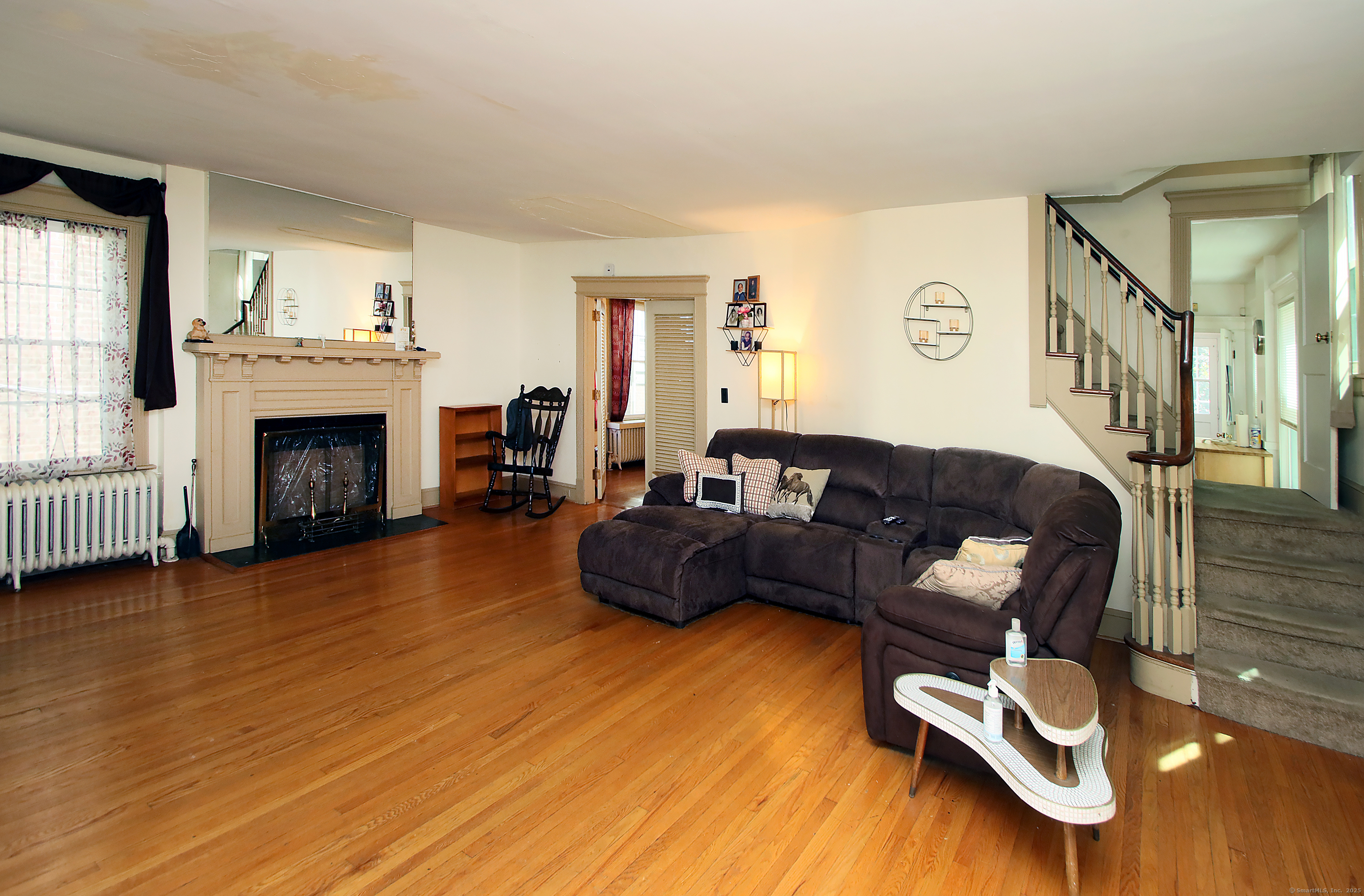 181 Buckingham Street Waterbury, CT 06710 - Photo 7 of 40 a living room with furniture and a fireplace