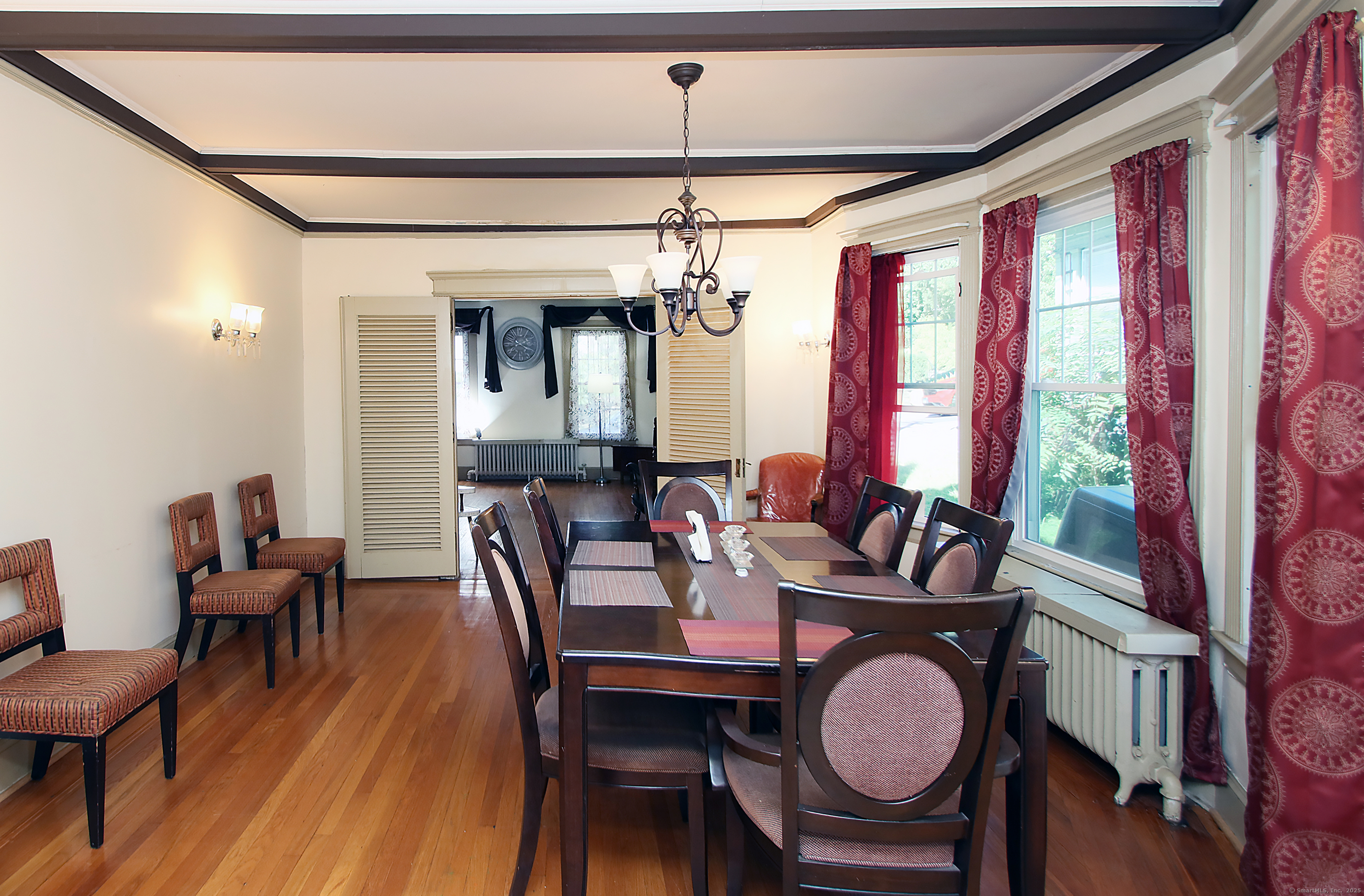 181 Buckingham Street Waterbury, CT 06710 - Photo 8 of 40 a dining room with furniture a chandelier and wooden floor