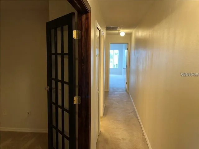 a view of a hallway with a door