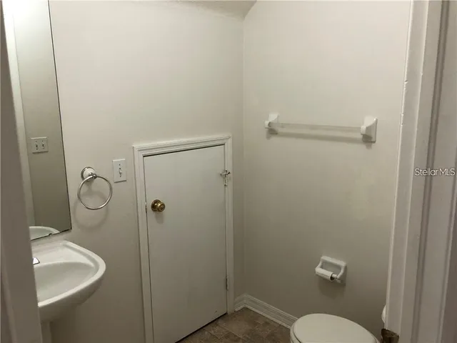 a bathroom with a granite countertop toilet a sink and shower