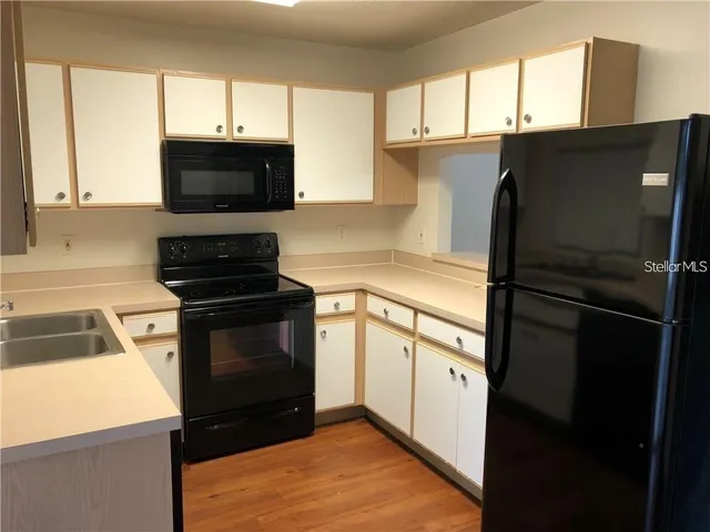 a kitchen with a refrigerator stove and microwave