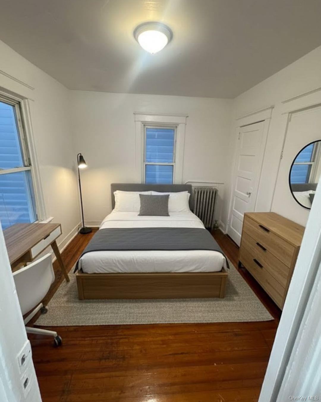 3581 Eastchester Road, Unit 2 Bronx, NY 10469 - Photo 2 of 13 a bedroom with a bed and wooden floor