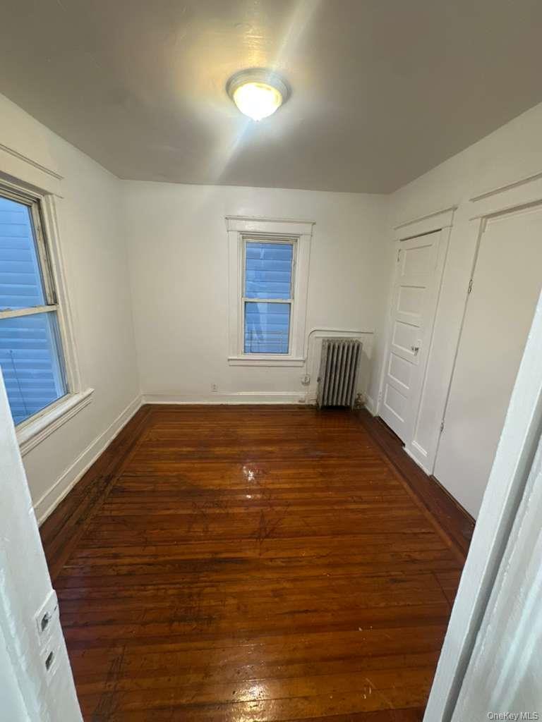 3581 Eastchester Road, Unit 2 Bronx, NY 10469 - Photo 4 of 13 a room with wooden floor and window