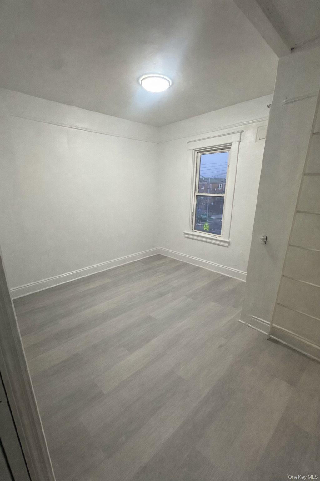 3581 Eastchester Road, Unit 2 Bronx, NY 10469 - Photo 10 of 13 an empty room with a window