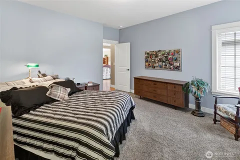a bedroom with double bed and a potted plant