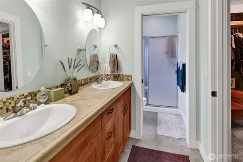 a bathroom with a sink double vanity and a mirror