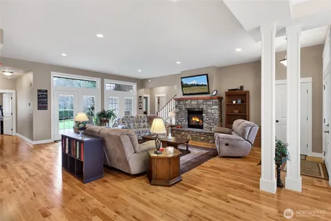 a living room with fireplace furniture and a wooden floor