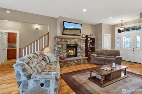 a living room with furniture fireplace and window